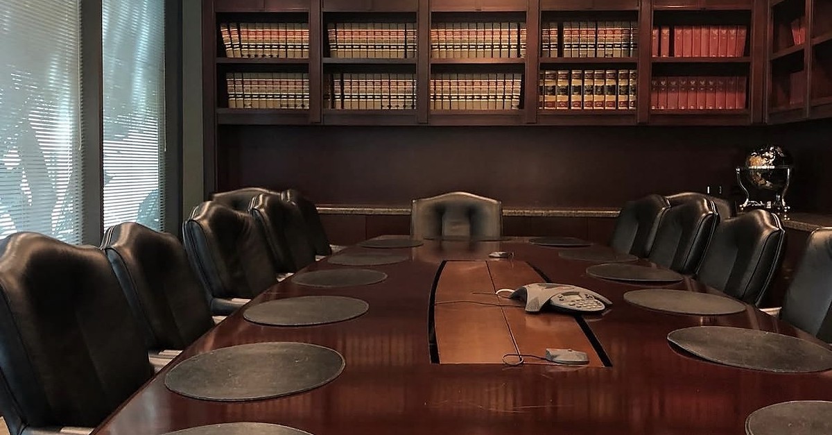 Conference room with law-book shelves and a wooden table at The Frey Law Firm